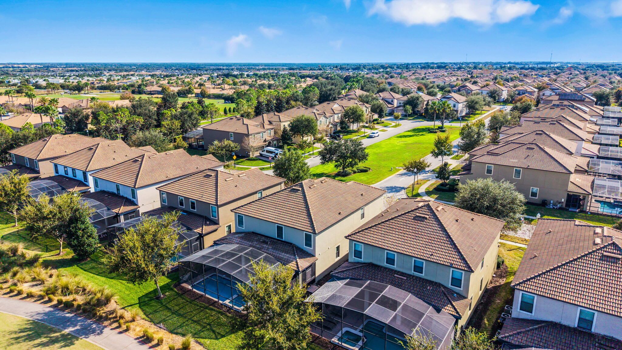 A residential area with modern houses featuring sloped roofs and solar panels.