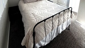 A bedroom with a bed, a window, and a door. - Workman’s Rest Pt. 2 – Quiet Upstairs 2BR for Working Travelers (Gillette)