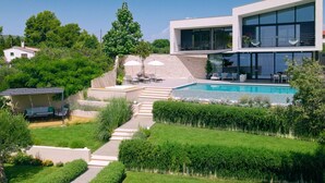A modern house with a swimming pool, a patio with outdoor furniture, and a well-maintained garden. - Villa Katina - Four bedroom Vila with pool and hot tub (Sucuraj)
