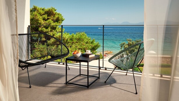 A balcony with a table, two chairs, and a view of the sea. - Villa Katina - Four bedroom Vila with pool and hot tub (Sucuraj)