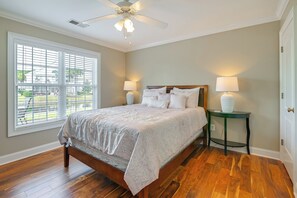 A bedroom with a bed, two bedside tables, a ceiling fan, and a window with blinds. - Spacious Home w/ Oceanside Village Resort Perks! (Murrells Inlet)