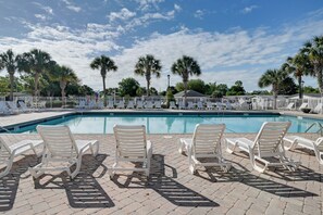 A swimming pool with lounge chairs and palm trees. - Spacious Home w/ Oceanside Village Resort Perks! (Murrells Inlet)