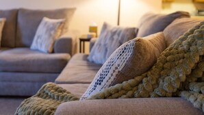 A living room with a sofa set and a knitted throw blanket. - Slope Views- Ski Shuttle- Pool & Hot Tub (Lincoln)