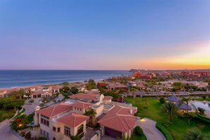 A coastal resort with Mediterranean-style architecture, featuring villas with red-tiled roofs, a central courtyard, and a view of the ocean. - Ocean View 3 BR Penthouse with Private Jacuzzi at Puerta del Sol, Cabo San Lucas (Cabo San Lucas)