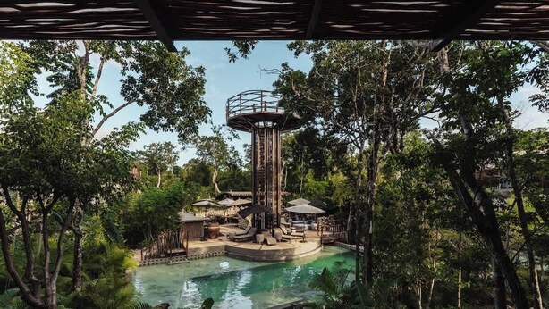 A water park with a central tower, a pool, and surrounding greenery. - Siwa Jungle Solstice C1-102 (Tulum)