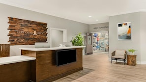 A reception desk with a wooden backdrop and a sign reading 'namaste spa'.