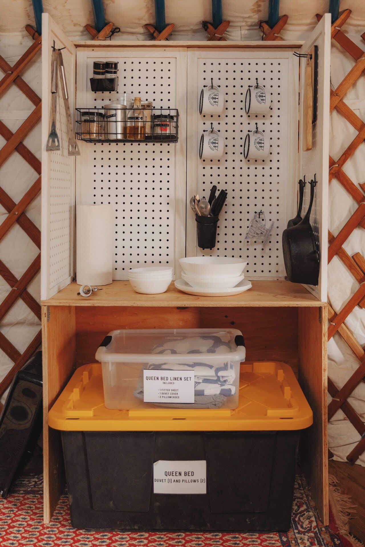 A storage unit with a queen bed linen set and a queen bed.