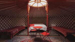 A traditional yurt with a central bed, two side beds, and a canopy overhead. - Glamping yurt at nature retreat in Sequoia NForest (Dunlap)