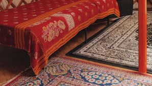 A traditional yurt interior with a bed, rugs, and a wooden lattice wall. - Glamping yurt at nature retreat in Sequoia NForest (Dunlap)