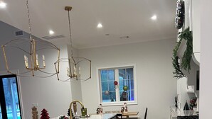 A modern kitchen with a large island, dark cabinetry, and a chandelier. - SPACIOUS 4-bdrm sleeps 10+,heated porch & tv’s, pool,hot tub,play room (Oxford)