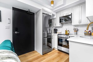 Fridge, microwave, oven, stovetop - The McCaul | Stylish Basement Suite w/ Laundry (Toronto)
