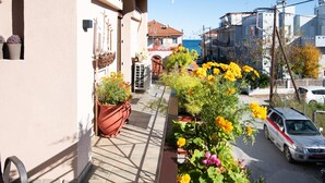 A narrow street with a building on the left and a parked car on the right. - Sunrise Suite Olympiada - Luxury Beachfront Escape (Aristotelis)