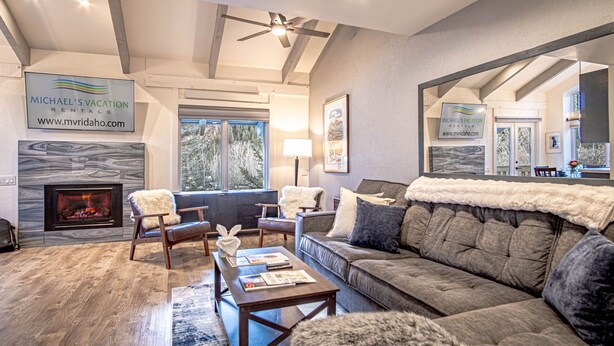 A modern living room with a fireplace, comfortable seating, and a ceiling fan. - Sv124- Walk to Lifts and Town-hot tub & Pool (Ketchum)