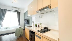 Standard Studio, 1 Bedroom | Private kitchen - Warm Tone Studio At Sky House Bsd Apartment (Pagedangan)