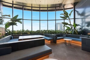 A modern interior with a curved ceiling, large windows, and seating areas. - Cozy & Stylish 1B in the Heart of Brisbane C34 (Brisbane City)
