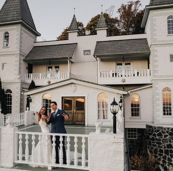A large, historic building with multiple balconies and a grand entrance.