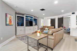 TV, computer monitors - Pink Pineapple ~ Walk to Downtown ~ Chic Heated Pool Home (Cape Coral)