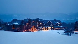 A large, multi-story lodge with a prominent entrance and a snow-covered landscape in the background. - SKI-IN, SKI-OUT Breckenridge Bliss, 1-BR Luxury Resort w/Hot Tubs, Pool, Theater (Breckenridge)