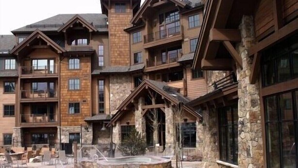 A multi-story lodge with a pool area, stone and wood exterior, and balconies. - SKI-IN, SKI-OUT Breckenridge Bliss, 1-BR Luxury Resort w/Hot Tubs, Pool, Theater (Breckenridge)
