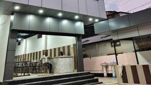 A modern building with a sign reading "ORIGIN" and another sign in a different language. - Hotel Origin (Guwahati)