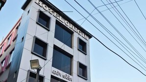 A modern hotel building with a sign reading "HOTEL ORIGIN". - Hotel Origin (Guwahati)