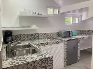 Fridge, stovetop, coffee/tea maker, dining tables