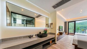 A modern bathroom with a large mirror, a black sink, and a potted plant. - Shenshan Wild Escape (Huzhou)