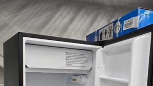 An empty refrigerator with clear shelves and a warning label on the door. - A cozy getaway for a quiet relaxing spell. (Vaughan)