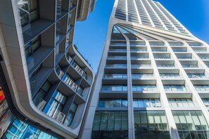 A modern high-rise building with multiple balconies and large windows. - Official Mercury Suites With Rooftop Pool Access (St. Julian's)