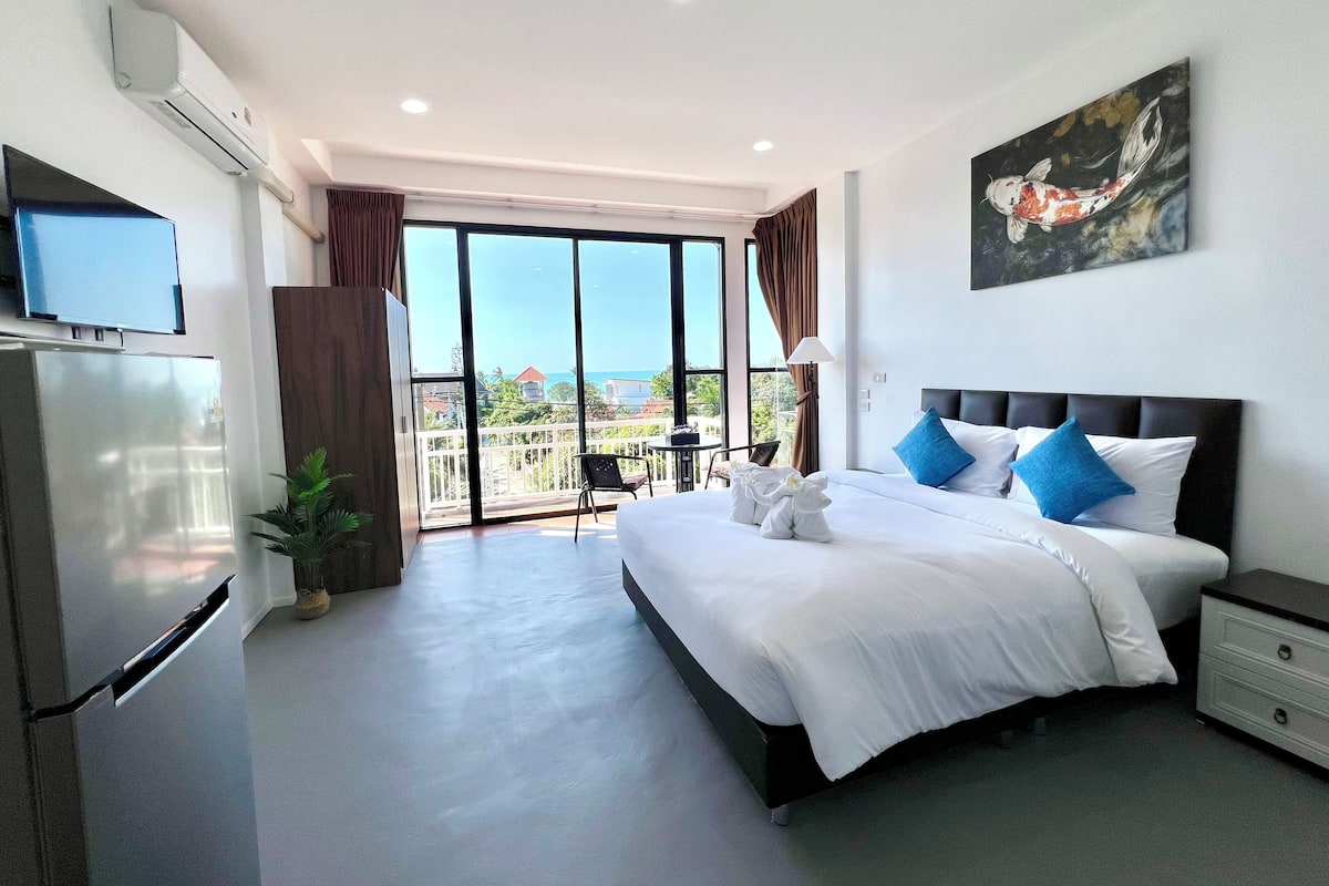 Habitación doble Deluxe, balcón, vista al mar | Espacio para trabajar con laptop y tabla de planchar con plancha