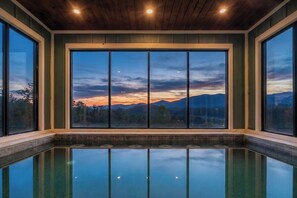 A pool with a view of mountains at sunset. - Sierra Splash Lodge | Pool/Theater | Sleeps 72 (Sevierville)