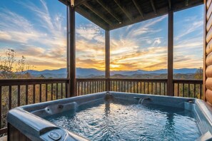 A hot tub with a view of mountains and a sunset. - Sierra Splash Lodge | Pool/Theater | Sleeps 72 (Sevierville)