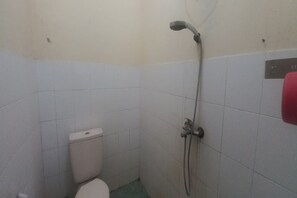 A small, tiled bathroom with a toilet and a shower. - OYO 95055 Homestay Panasan Pak Budi (Sambi)
