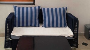 A room with a sofa, a coffee table, and a tiled floor. - Pearl Pride Villa (Udaipur)