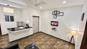 Executive Room | Living area | 32-inch TV with cable channels - The Base Inn (Vanur)