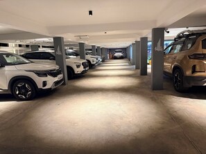 A parking garage with multiple rows of parked cars. - The Base Inn (Vanur)