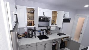 A compact kitchen with white cabinets, a built-in oven, and a coffee station. - Comfort, location and a fair price, ALL IN ONE PLACE (Las Vegas)