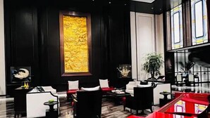 A modern lobby with a red grand piano, black and white seating, and a large decorative wall. - CANTON HOTEL BEIJING (Beijing)