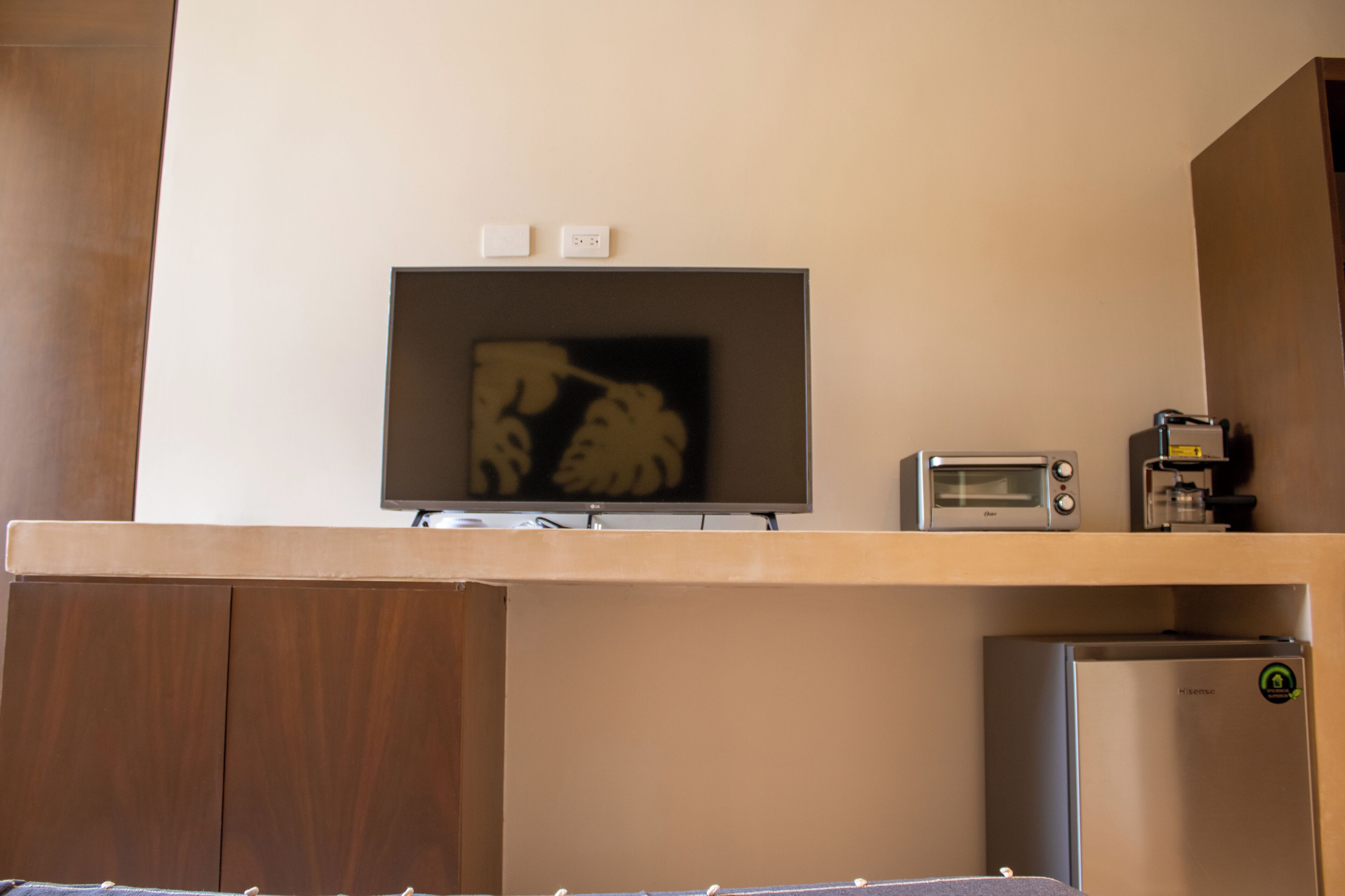 A kitchenette with a built-in microwave, a small refrigerator, and a toaster.