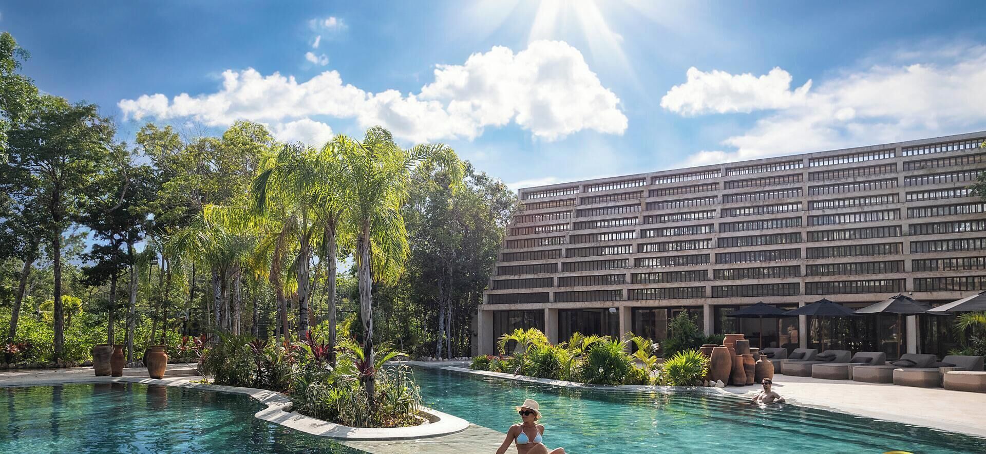 A swimming pool with a modern building in the background.
