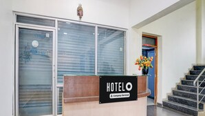 A hotel reception desk with a sign reading 'HOTELO' and a 'Company-Serviced' label. - Super Hotel O Pachgaon (Kolhapur)