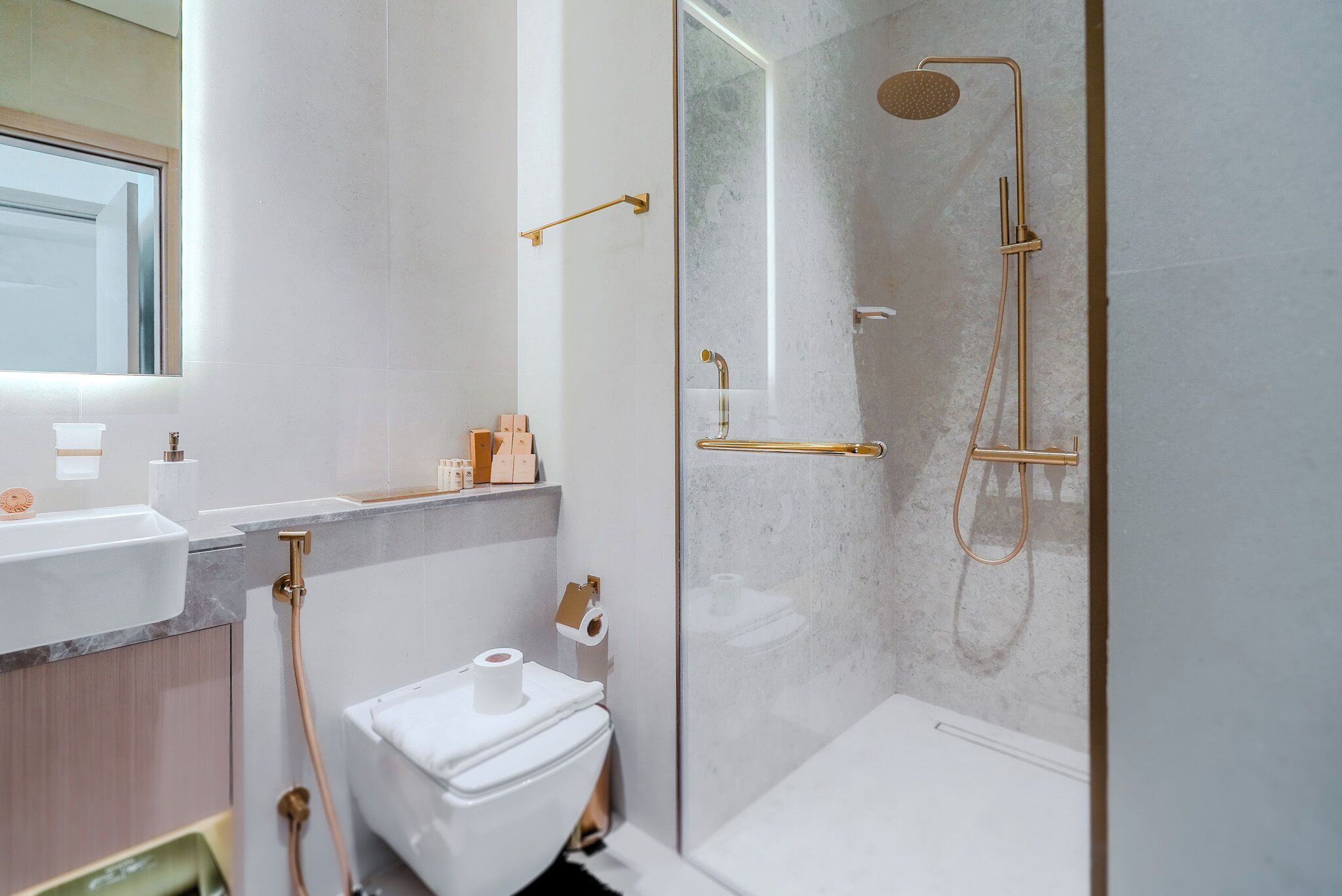 Ein modernes Badezimmer mit Toilette, Waschbecken und Duschbereich.