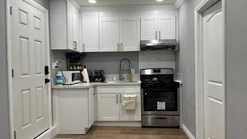 Fridge, microwave, cookware/dishes/utensils, spices