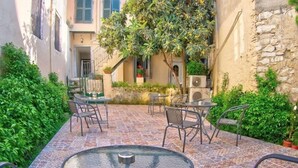 A courtyard with outdoor seating, a small pool, and a tree. - Indigo Apartment by Corfuescapes  (Corfu)