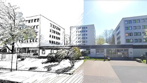 Um edifício moderno com vários andares, grandes janelas e área de entrada pavimentada com um caminho.