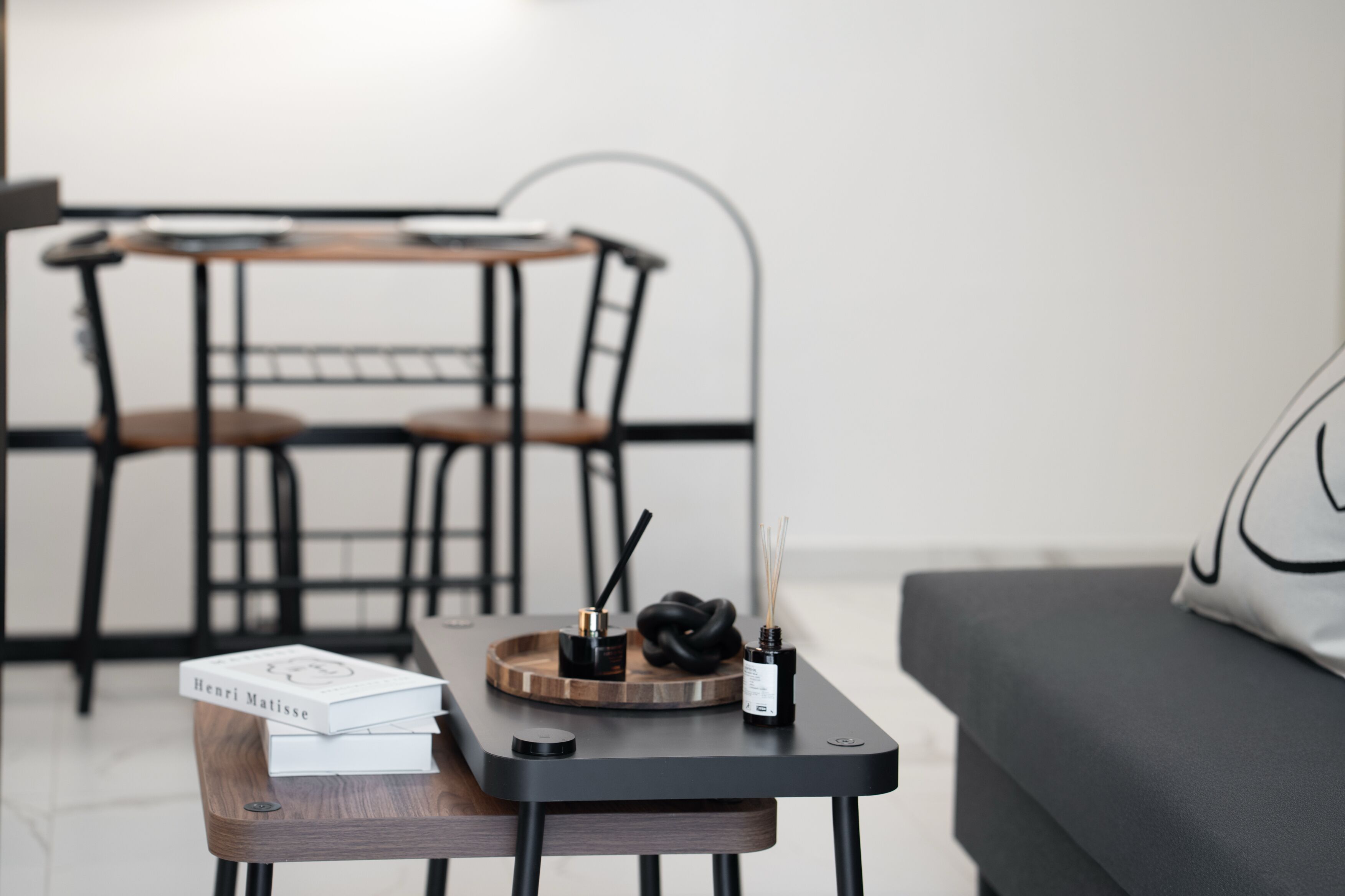 A modern living room with a coffee table, a sofa, and a dining table with chairs.