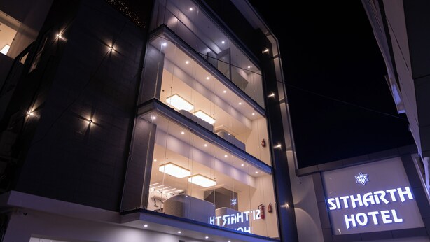 A modern hotel with a prominent sign reading "SITHARTH HOTEL." - Sitharth Hotel (Vikasnagar)