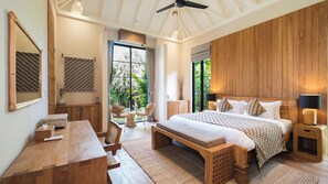 A spacious bedroom with a large bed, wooden headboard, and a view of greenery through the window. - Exclusive 5-Bedroom Luxury Villa in Canggu, Walking Distance to the Beach! (Tanggu)