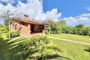 A single-story house with a brown exterior, a small porch, and a well-maintained garden. - <b></b>Located on the southeastern coast of Sardinia, 20 km from Villasimius, <b>Villa Venere</b> is situated approximately 2 km from the center of Costa Rei. Surrounded by a spacious and well-kept private garden of about 200 sqm, this charming villa is  (Costa Rei)