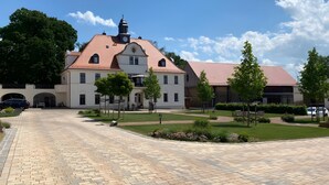 Un grand bâtiment doté d’un clocher, d’une allée pavée et d’une pelouse bien entretenue.